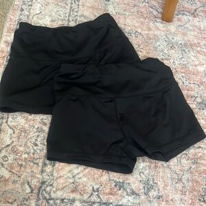 two pairs of black workout shorts